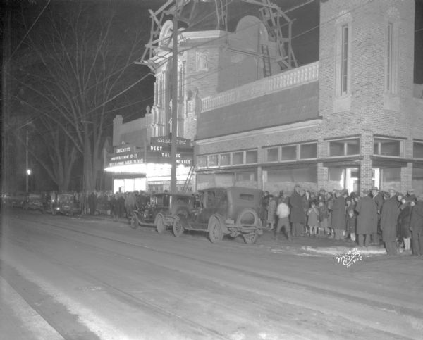 A crowd lined up on opening night at the Eastwood Theatre at 2090 Atwood Avenue. This view of the facade shows an unfinished dome on top of the building.