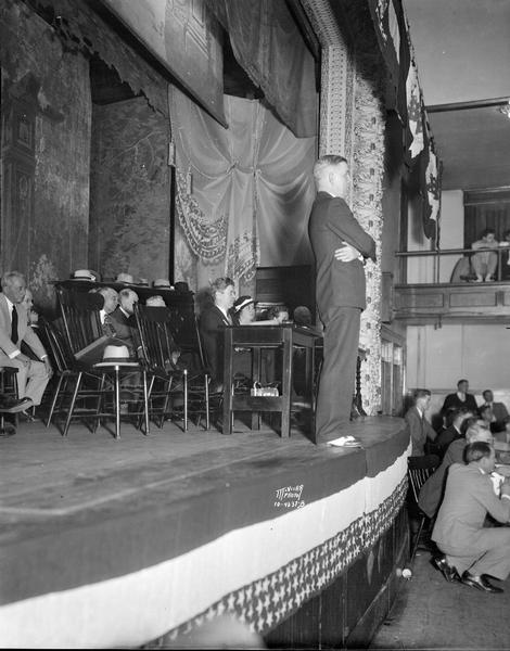 William T. Evjue, editor of The Capital Times, presiding over the Progressive convention, at which the delegates launched a new political party, the Progressive Party. Philip La Follette and several others are sitting on the stage.