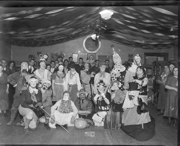 Group of people posing in Halloween costumes at the Italian Workingmen's Club at 914 Regent Street in the Greenbush neighborhood.