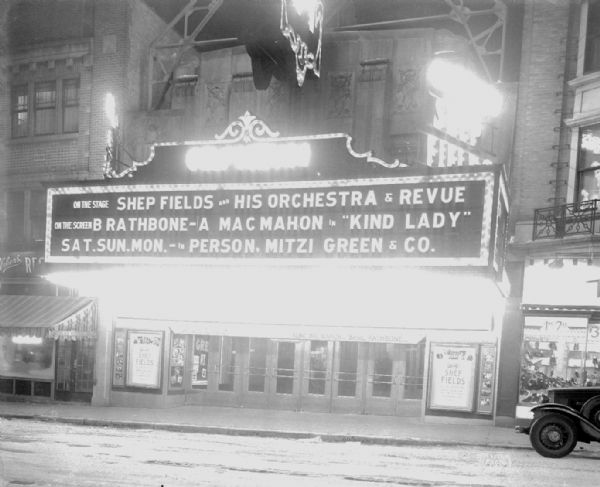 Orpheum Theatre marquee lit up at night that says: "On the stage Shep Fields and his orchestra & revue, on the screen B. Rathbone - A. MacMahon in 'Kind Lady,' in person Mitzi Green & Co."