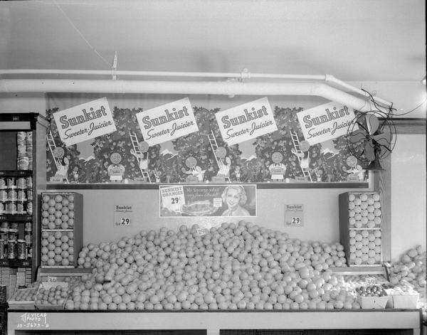 Sunkist Display California Fruit Exchange Sunkist oranges display with signs that read: "Sweeter-Juicier" and "Sunkist Oranges 29 cents 'My favorite salad' says Joan Blondell."