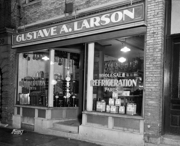 Gustave A. Larson storefront, 205 E. Main Street. Wholesale refrigeration parts and Texeco Capella Oil.
