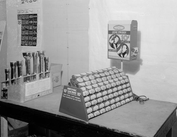 Pyramid display of Ray-O-Vac batteries with a battery testing machine attached to the display. "10 Cents Leak Proof Metal Covered Batteries Can't Stick...Can't Damage Read Guarantee on Battery" Also shows back side of flashlight display.
