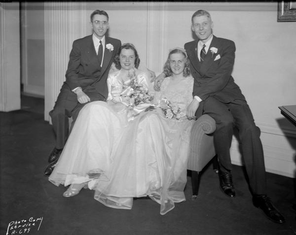Bride and groom, Marjorie Bakken and William N. Schink, posing with the best man, Norbert Schmitz, and maid of honor, Vivian Milburn, posing at the Madison Club.