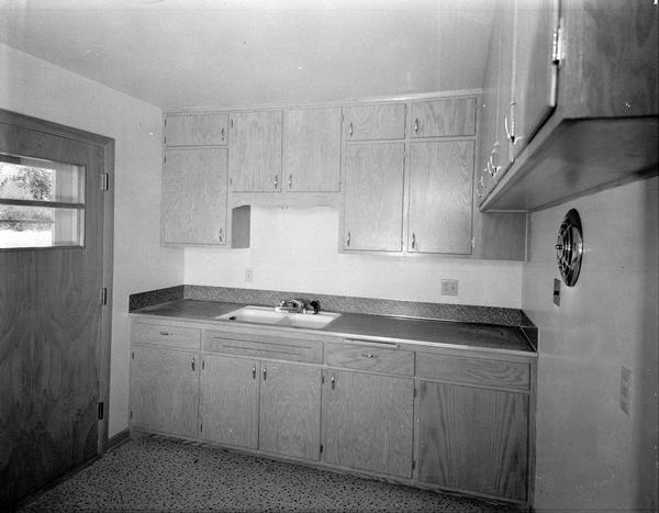 Kitchen sink and cabinets installation by Monona Manufacturing and Supply Company, 4709 Monona Drive.