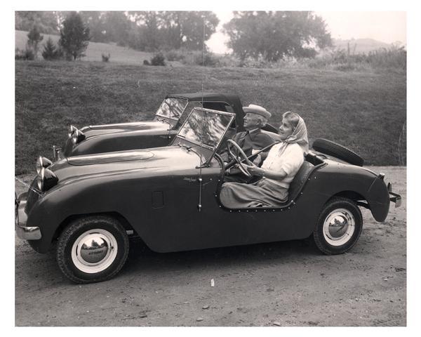 Frank Lloyd Wright and Olgivanna Lloyd Wright, motoring in the country in a Crosley car. Another car is behind them.