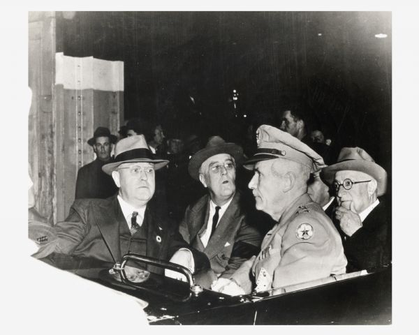 Franklin D. Roosevelt, Wisconsin Governor Julius P. Heil, and other officials touring the Allis-Chalmers plant.