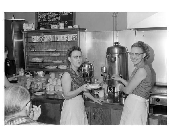 Two women serving coffee to customers at a coffee shop. Richland Center, Wisconsin.