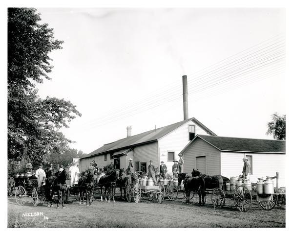 Farmers delivering their milk in wagons to a dairy plant on Black Creek Road near Appleton.  The advent of automobiles would vastly improve farmers ability to take their goods to market.