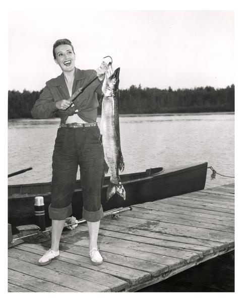 Gypsy Rose Lee (aka Louise Hovick, 1914-1970) with a large muskie she caught in a northern Wisconsin lake.