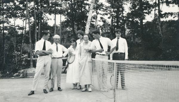 Four men and three women posing on Hull's tennis court.