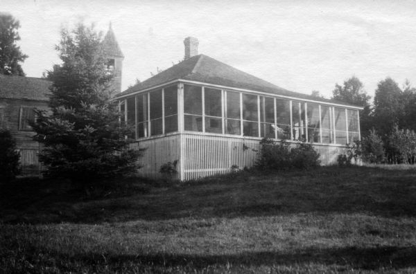 View across lawn of the Church Cottage and Congregational Church on Madeline Island.