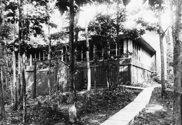 Outside view of the Hull Cottage porch, including the boardwalk leading from the lake.