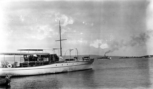 Hull family boat "Zenya" near shore with boat "Skater" in the background off shore.