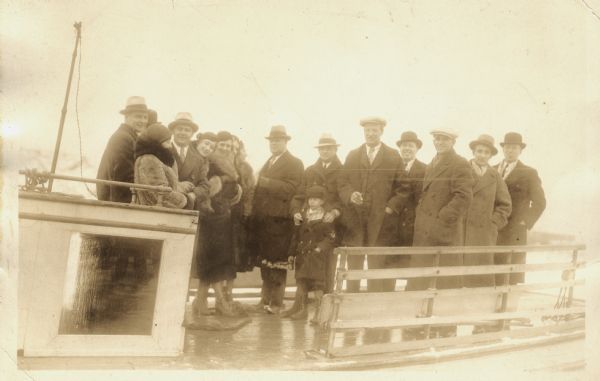 Group of people standing on board a passenger ferry bound for a New Year's trip to Ashland.