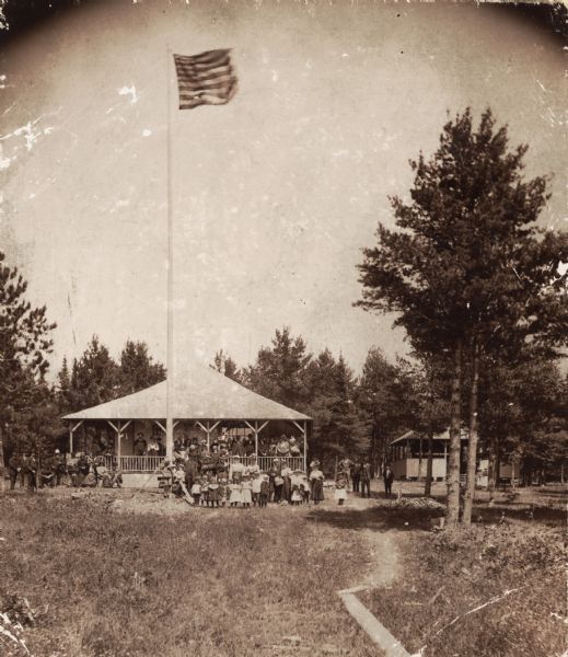 Pavilion with posed group of picnickers on one of the Apostle Islands.