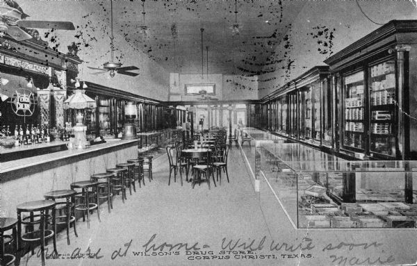 Interior view of soda fountain and confectionary, part of Wilson's Drugstore. Caption reads: "Wilson's Drugstore, Corpus Christi, Texas."