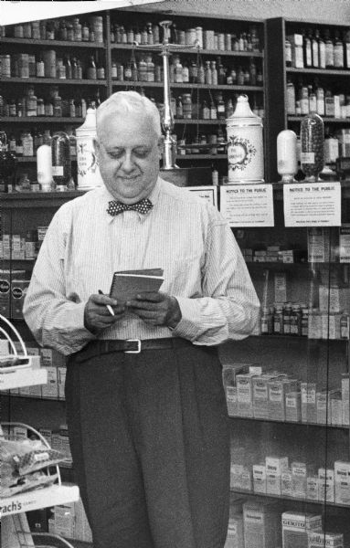 Edward Farber, a prominent Milwaukee druggist, double checks a prescription order on the day before he retired. Farber operated his popular drugstore, located at 4217 W. North Avenue, for 43 years.