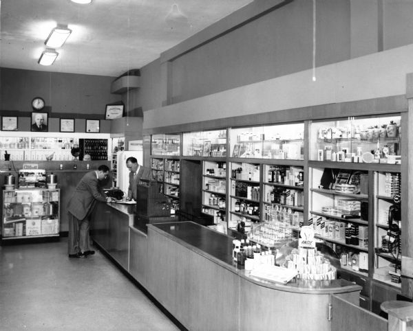 A customer pays for his medication at the Lascoff Pharmacy.

