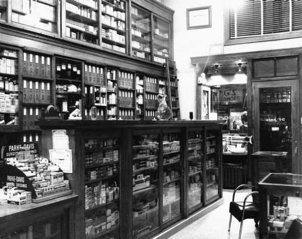 View of the interior of D.F. Jones' Pharmacy, showing an assortment of shelving compartments for items in the store.