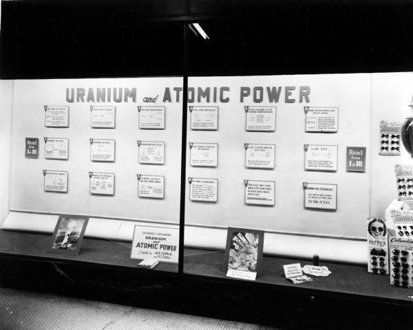 Display in the window of a pharmacy, explaining what happens to uranium as atomic power is produced.
