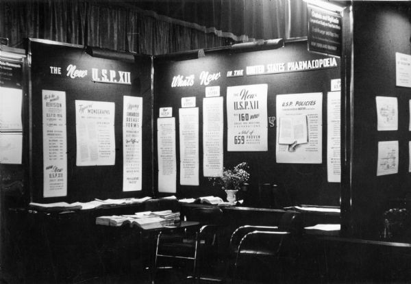 View of the U.S. Pharmacopeia's exhibit at the American Medical Association's 1942 Conference in Atlantic City, detailing the revisions and additions of various drugs.