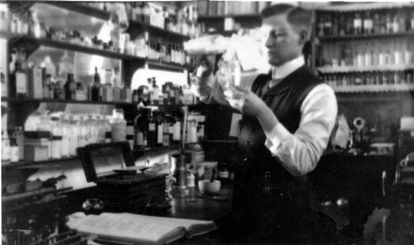 Rial Herreman prepares a mixture in the laboratory of his drugstore in Boyd, Wisconsin.