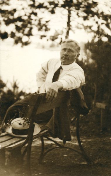 Notable University of Wisconsin pharmacist Edward Kremers relaxes on a bench in a park near the time of the Wisconsin Pharmacy State Convention in 1916.