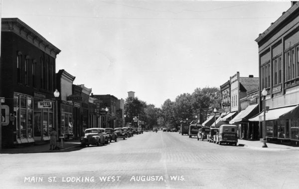 Caption reads: "Main St. Looking West. Augusta, Wis." Livesey Drugs is on the left side of the street.