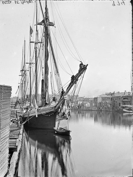 View downriver from the State Street Bridge showing a large sailing vessel.