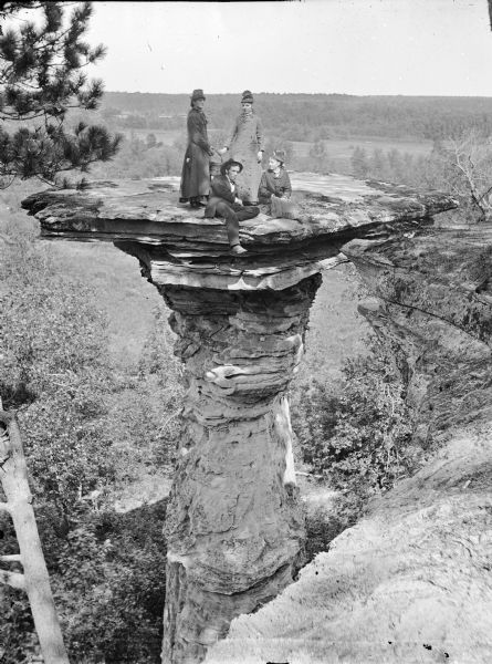 Individuals on Stand Rock Four unidentified individuals on Stand Rock.