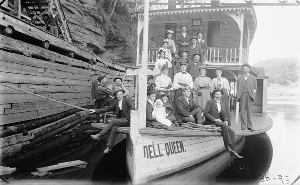 Bennett family posing on the bow of the "Dell Queen" steamboat.