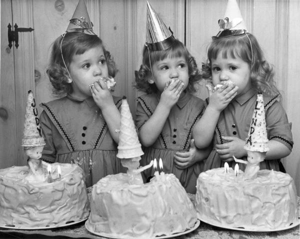 Second birthday party of Judy, Robin, and Linda Constantineau of 8106 W. Euclid Ave. All three girls are eating cake.