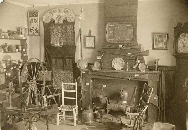 A collection of pioneer household articles arranged in a living room.