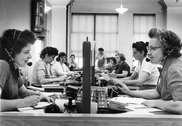 Female telephone operators busy at work.