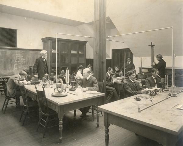 Students and teacher in physics lab at Stevens Point Normal School, which would later become the University of Wisconsin-Stevens Point.