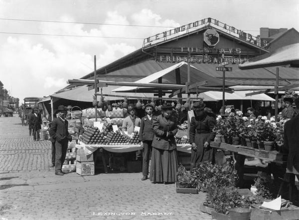 People standing and posing outdoors. Caption reads: "Lexington Market."
