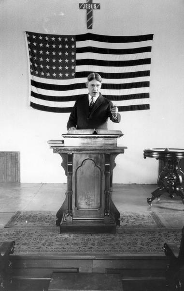 Preacher Chas V. Reed delivering a sermon on tuberculosis in conjunction with an International Harvester Agricultural Extension Department lecture. Mr. Reed was the preacher at Big Woods Congregational Church near Eola.