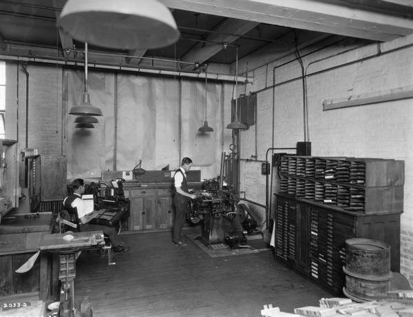 Workers setting type for printing documents or labels at a print shop operated by International Harvester's Agricultural Extension Department(?).