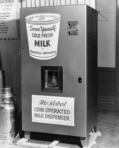 Mr. Robot, a coin operated milk vending machine promoted by the Wisconsin Dairy Caravan, dispenses milk into a paper cup.