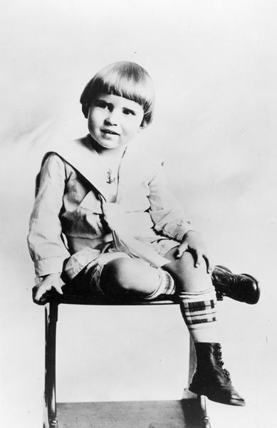 Portrait of Richard M. Nixon, seated, at four years of age, wearing a sailor suit and Dutch-boy haircut.