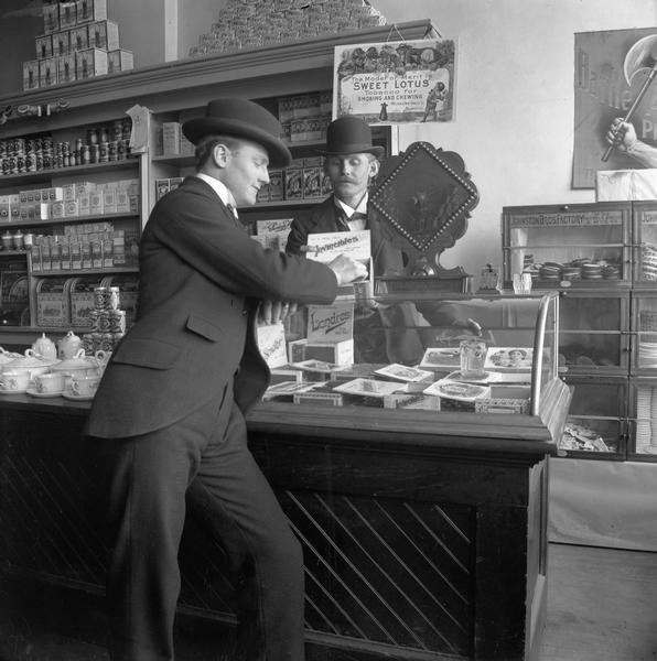 Will Viel chooses a cigar in Margraff & Freiburger's Dry Goods Store.