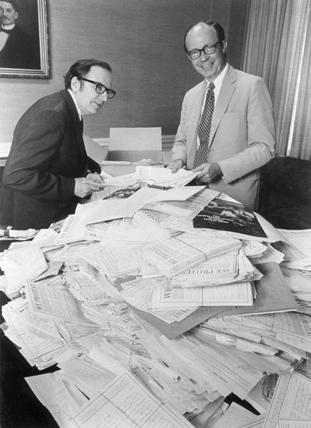 "Christian Herald" editor Kenneth L. Wilson, left, and publisher, Fen Loomer look through some of the over 25,000 pieces of mail with over 160,000 signatures supporting the magazine's protest against sex and violence on television.
