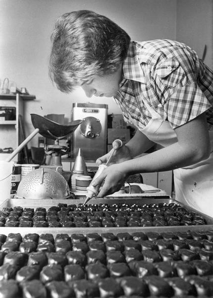 Jim Niemann decorates dipped chocolates at his family's business, Niemann's Home Made Chocolate Shop.