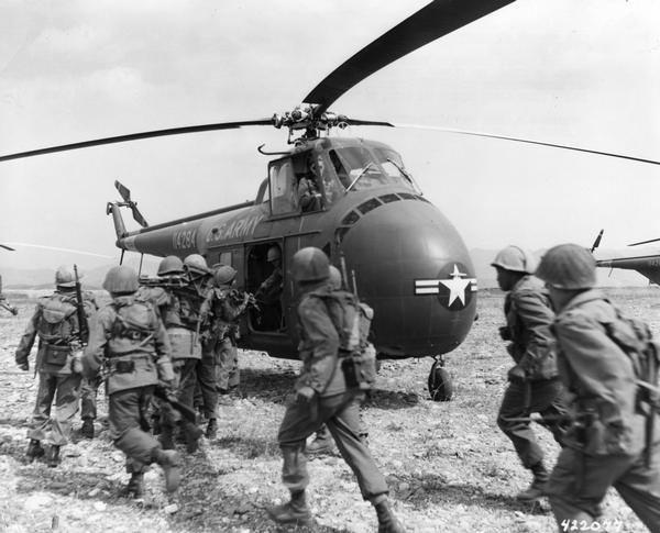 Infantry troops board helicopters for Korea via the 6th Transportation Helicopter Company, the first Army cargo helicopter unit in the combat zone. The 6th was called up in November 1952 and arrived in Korea with their H-19C helicopters in January, 1953.  The armistice was signed, several months later, on July 27.  For Joseph R. McCarthy and the conservative Republicans the ceasefire meant that there were be no victory over Communism in Korea.