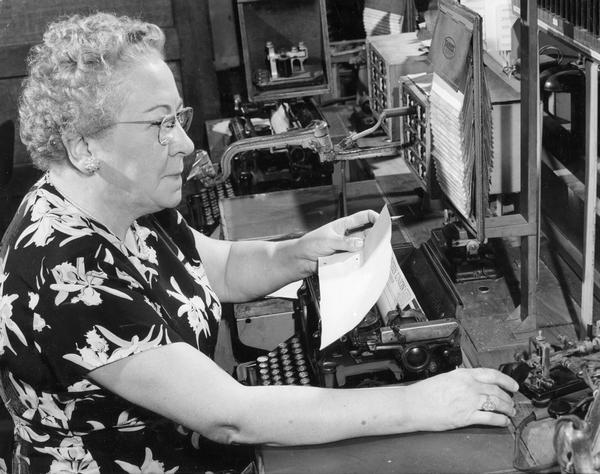 Miss Nellie Millane sits at the telegraph key at Western Union Telegraph Co. where she worked as a Morse Code operator for 49 years.