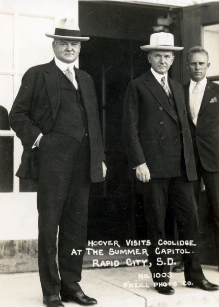 Herbert Hoover visits President Calvin Coolidge during Coolidge's summer retreat from the heat, crowds, and a White House renovation in Washington, D.C. Caption reads: "Herbert Hoover visits President Calvin Coolidge at the Summer Capitol. Rapid City, S.D."