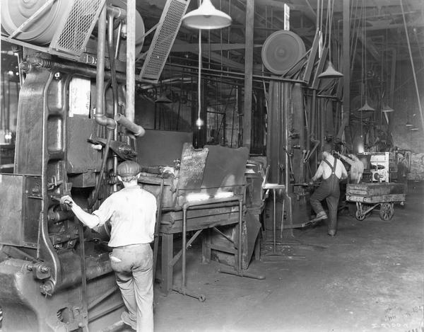 Men operating large machines at International Harvester's Springfield Works. The factory produced trucks.