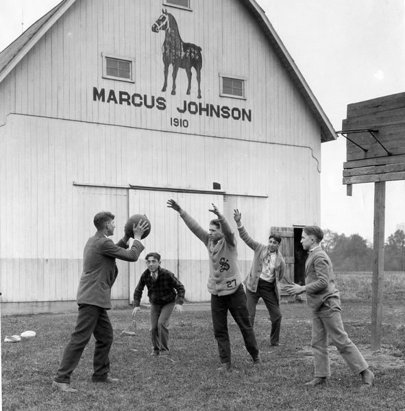 Boys practicing for winter basketball games on the farm of Marcus Johnson.