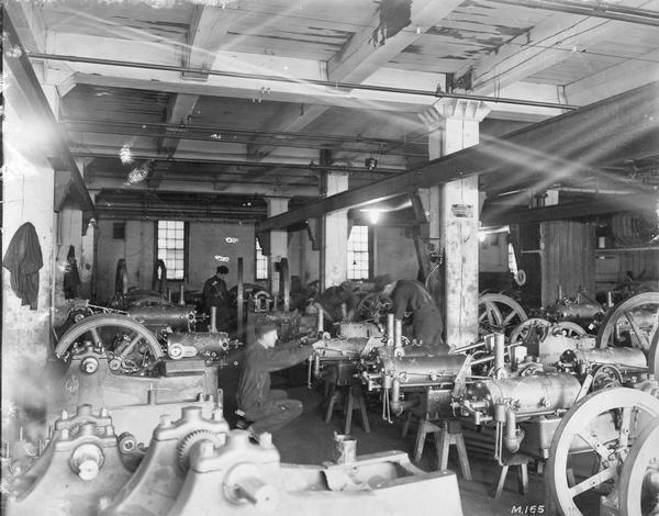 Employees working on stationary engines at International Harvester's Milwaukee Works. The factory was owned by the Milwaukee Harvester Company until 1902.